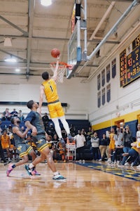 a basketball player dunks the ball during a game