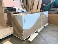 a wooden cabinet is being made in a workshop