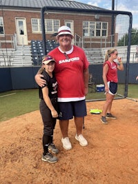 a group of softball players posing for a picture