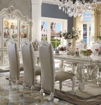 an ornate dining room set with a chandelier