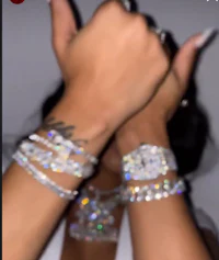 a woman wearing a bracelet with diamonds on it
