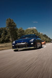 a nissan gt-r driving down a road