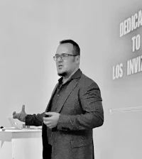 a man giving a presentation in front of a screen