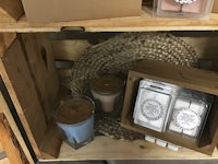 a wooden crate with candles and other items on it