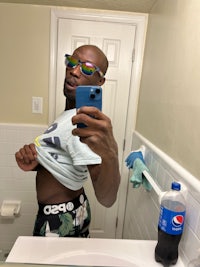 a man taking a selfie in a bathroom