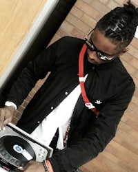 a man with glasses and a dj turntable