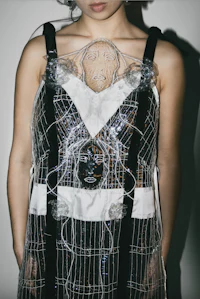 a woman wearing a dress made of transparent plastic