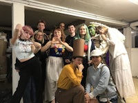 a group of people posing for a photo in a garage
