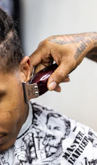 a man is getting his hair shaved