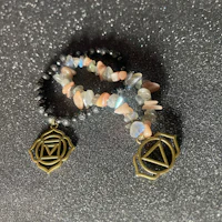 a pair of bracelets with a heart and an om symbol on them