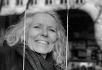 a black and white photo of a woman smiling
