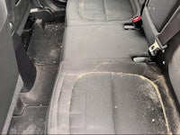 the back seat of a car with dirt on it