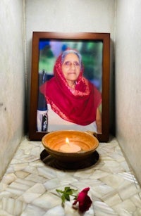 a photo of an indian woman with a candle in front of it