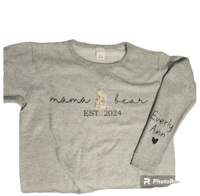 a grey sweatshirt with the word mama bear on it