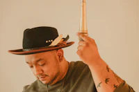 a man wearing a hat and holding a gun