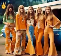 a group of young women in orange outfits posing in front of a car