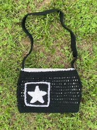 a black and white crocheted bag with a star on it
