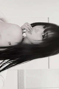 a black and white photo of a woman with long black hair