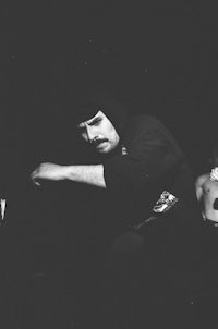 a black and white photo of a man with a mustache