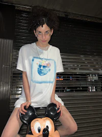 a woman wearing a mickey mouse t - shirt