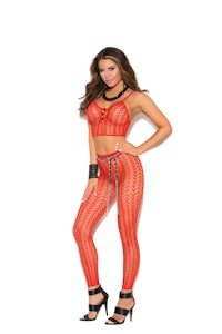a woman is posing in a red fishnet set