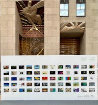 a large display of photos in front of a building