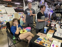 a group of people at a booth at a market