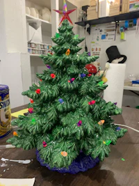 a ceramic christmas tree sitting on a table