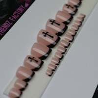 a set of pink and black nails with crosses on them