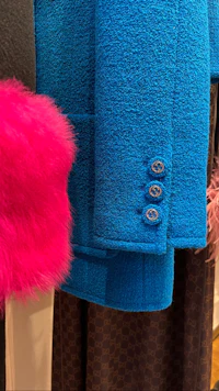 a blue coat with pink fur and a pink fur hat