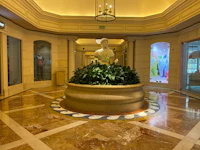 the lobby of a hotel with a statue in the center