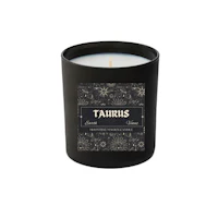 a candle with the word taurus on it