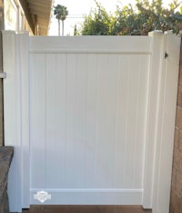 a white wooden gate in a backyard