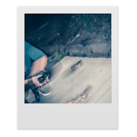 polaroid photo of a man riding a skateboard