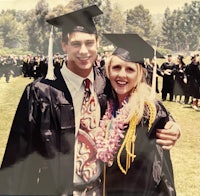 a man and woman posing for a graduation photo