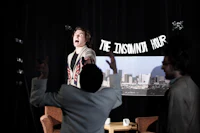 a group of people in a room with a sign that says the zippo man