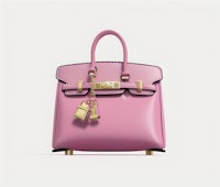 a pink handbag with gold hardware on a white background