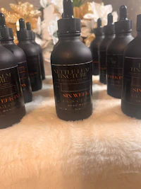 a group of black bottles on a white table