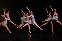 a group of dancers performing on stage