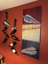 a wine rack with wine bottles hanging on the wall