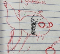 a child's drawing of a fish in a notebook