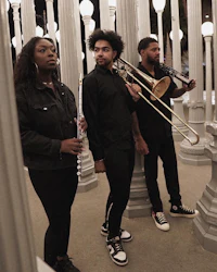 a group of people standing in front of a group of pillars