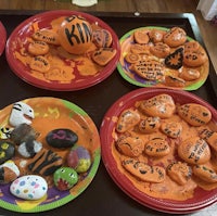 a group of plates with painted rocks on them