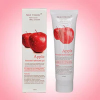 a tube of apple peeling cream on a pink background