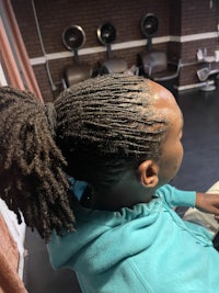 a woman with dreadlocks sitting in a chair