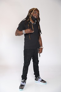 a man with dreadlocks posing for a photo