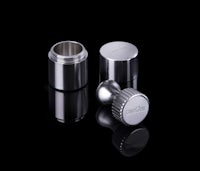 a set of stainless steel lids on a black surface
