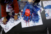 a child's hand is painted with red and blue paint