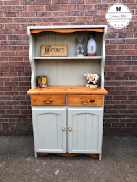a hutch with two drawers and a wooden top