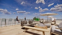 a rendering of a rooftop deck with furniture and umbrellas